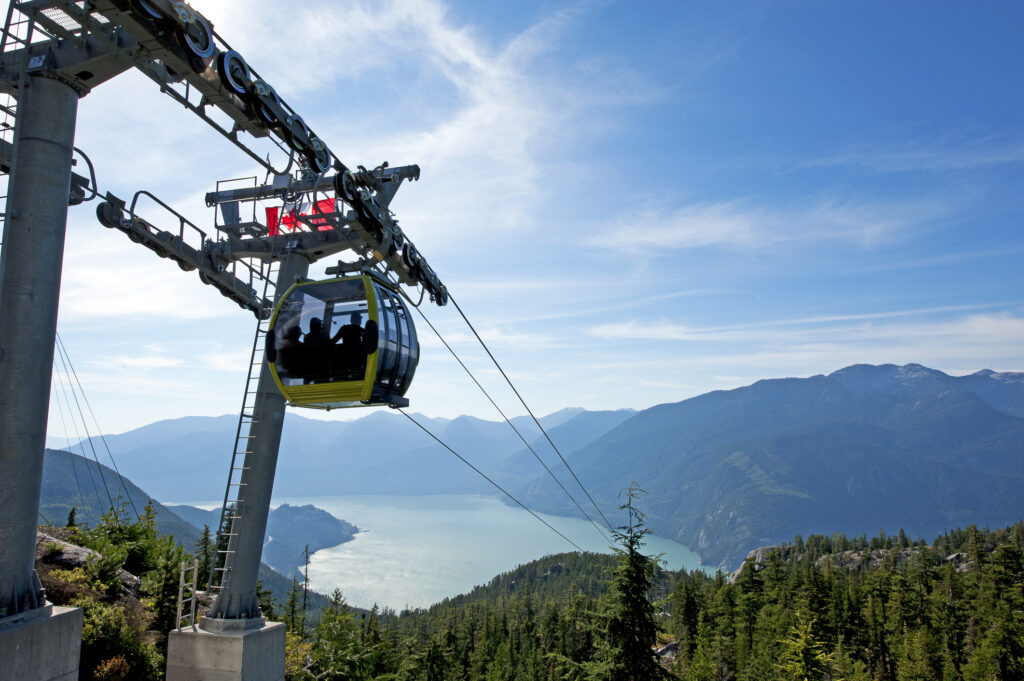 A cable car gondola overlooking Vancouver's mountains and forests.