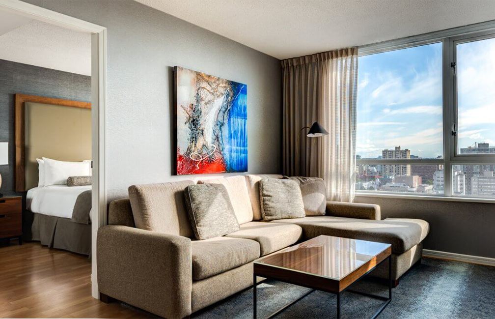Living room with a city skyline view at Carmana hotel in Vancouver.