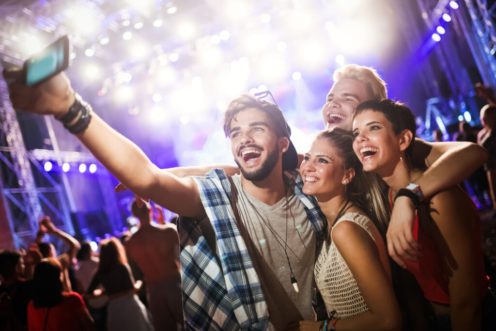 Friends taking a selfie at a concert.